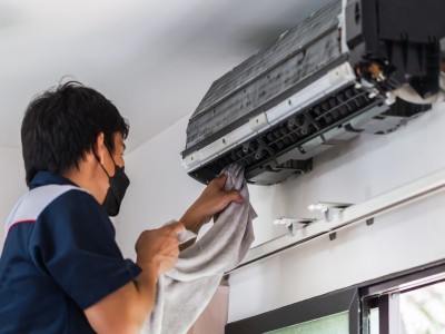 Industrial AC service technician maintaining a cooling system in an Al Quoz warehouse Dubai