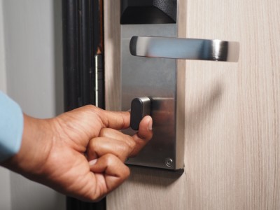 Homeowner struggling with door lock repair showing DIY mistake