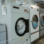 Technician fixing washing machine problem in Dubai laundry room