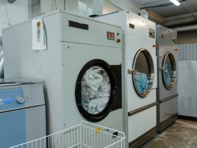 Technician fixing washing machine problem in Dubai laundry room