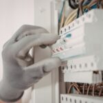 Technician inspecting a water pump after repeated breaker trips in a Dubai home
