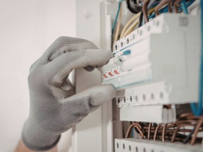 Technician inspecting a water pump after repeated breaker trips in a Dubai home