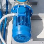 Technician inspecting a water pump that is running but not delivering water in a Dubai home