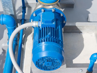 Technician inspecting a water pump that is running but not delivering water in a Dubai home
