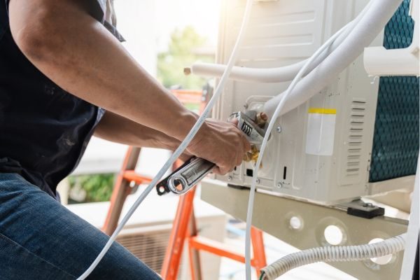 Technician fixing an air conditioner in Dubai