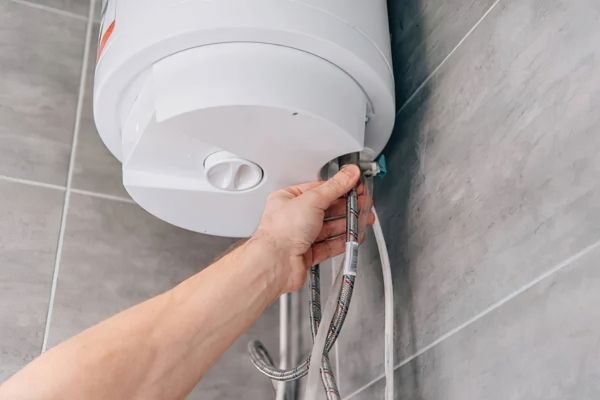 Repairman fixing a water heater in a home in Dubai
