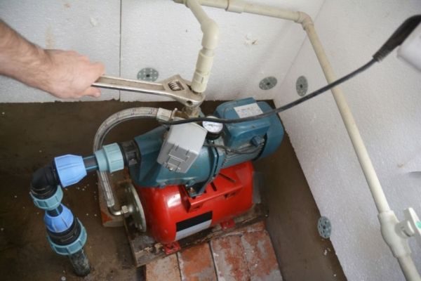 Worker repairing a water pump in Dubai
